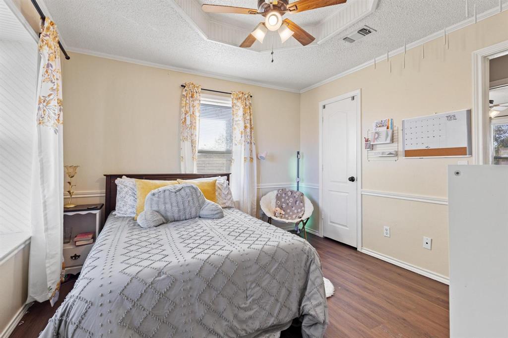 625 County Road Paris, TX 75462 - Photo 17 of 31 a bedroom with a bed and wooden floor