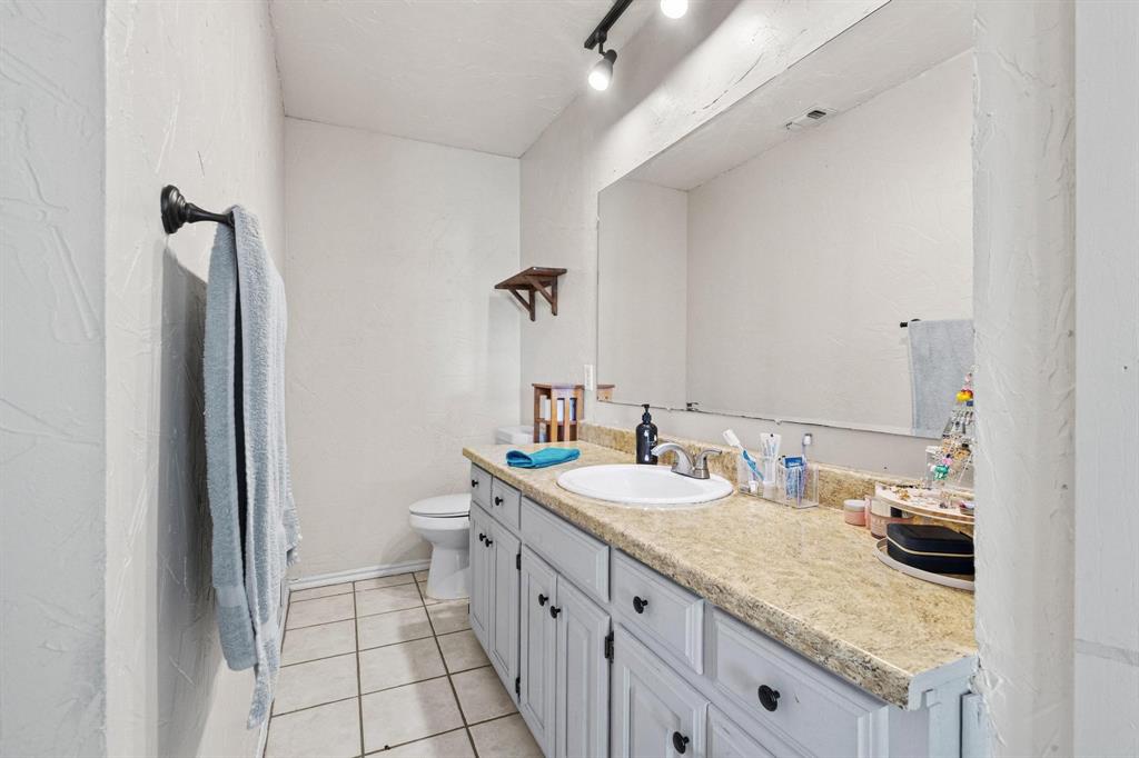 625 County Road Paris, TX 75462 - Photo 19 of 31 a bathroom with a granite countertop sink and a mirror