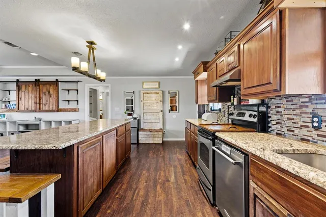 a kitchen with granite countertop lots of counter top space