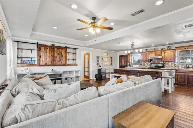 a living room with furniture and wooden floor