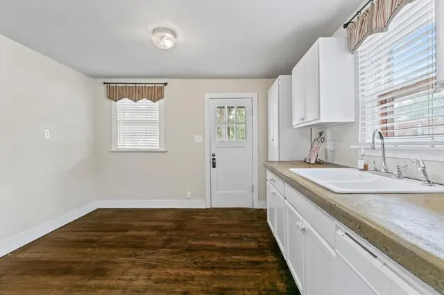 a kitchen with a sink stove and cabinets