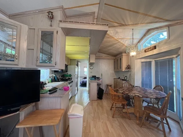 a view of a dining room with furniture and a window