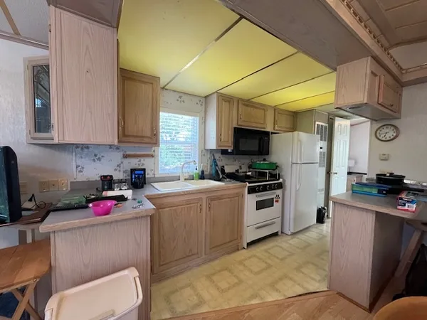 a kitchen with a sink cabinets and appliances