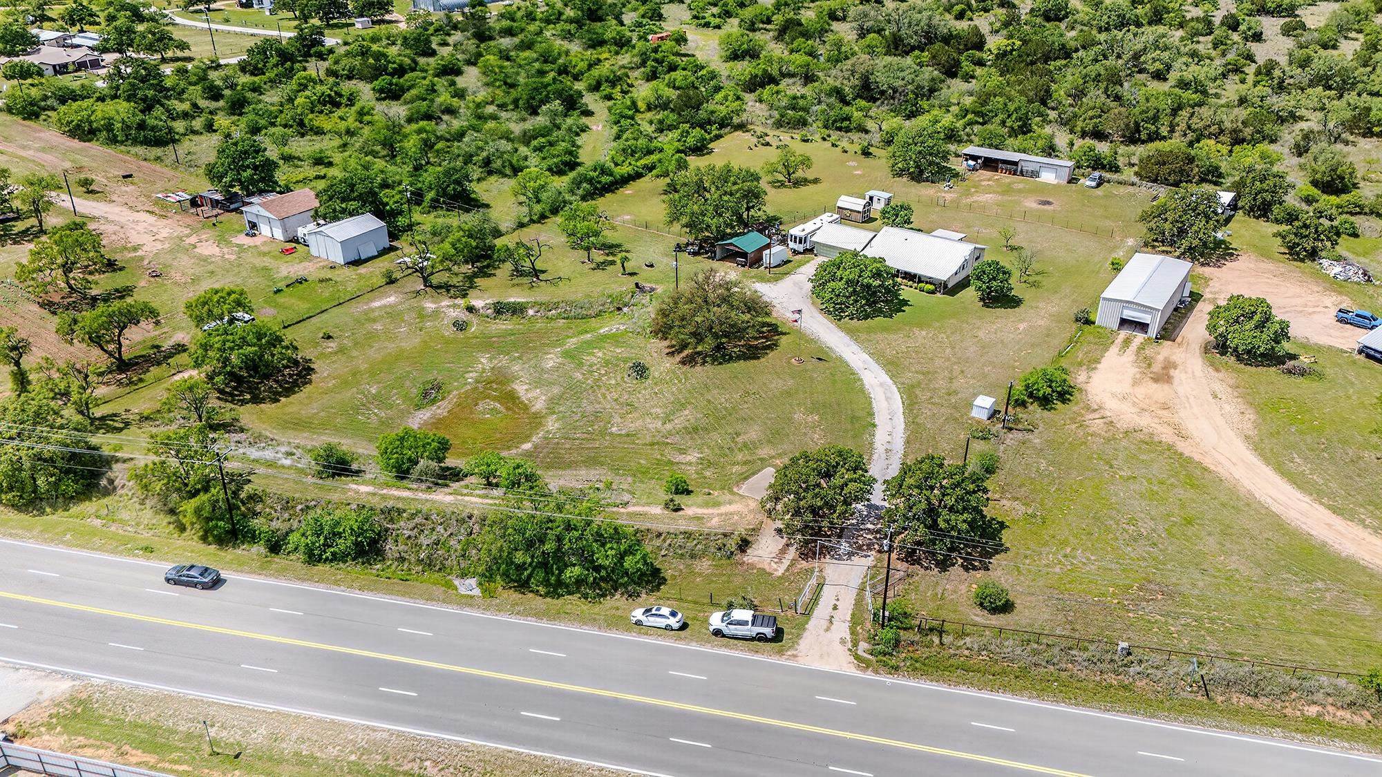 10465 Ranch To Market 1431 Buchanan Dam, TX 78609 - Photo 5 of 29 an aerial view of a residential houses with yard