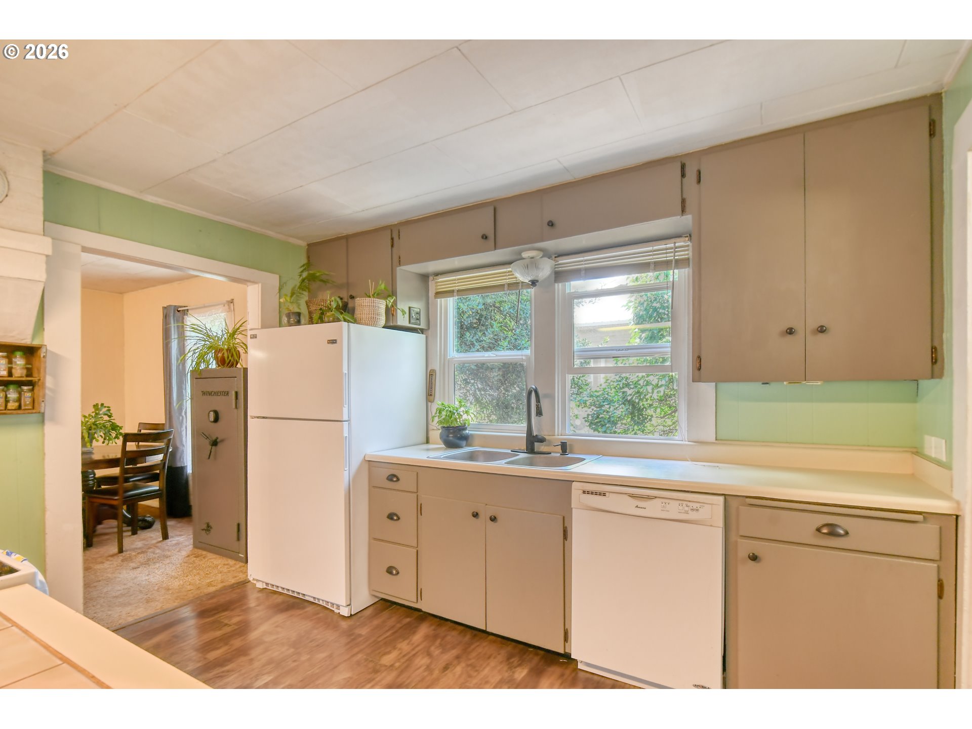 237 Southwest 2nd Street Pilot Rock, OR 97868 - Photo 20 of 34 a kitchen with a refrigerator a sink and dishwasher with wooden floor