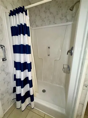 a bathroom with a shower and a sink