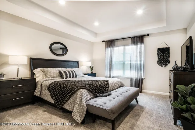 a bedroom with a bed a couch and dresser