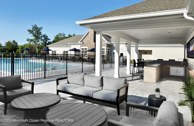 a balcony with furniture and a potted plant
