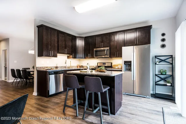 a kitchen with granite countertop stainless steel appliances and refrigerator