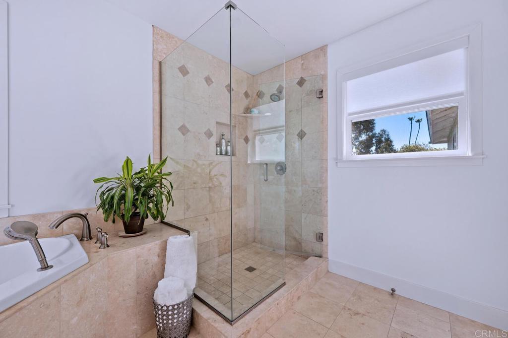 647 Arden Drive Encinitas, CA 92024 - Photo 21 of 36 a bathroom with a shower sink and mirror