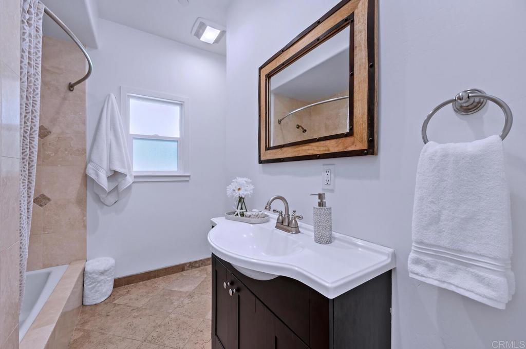 647 Arden Drive Encinitas, CA 92024 - Photo 24 of 36 a bathroom with a sink vanity and a mirror