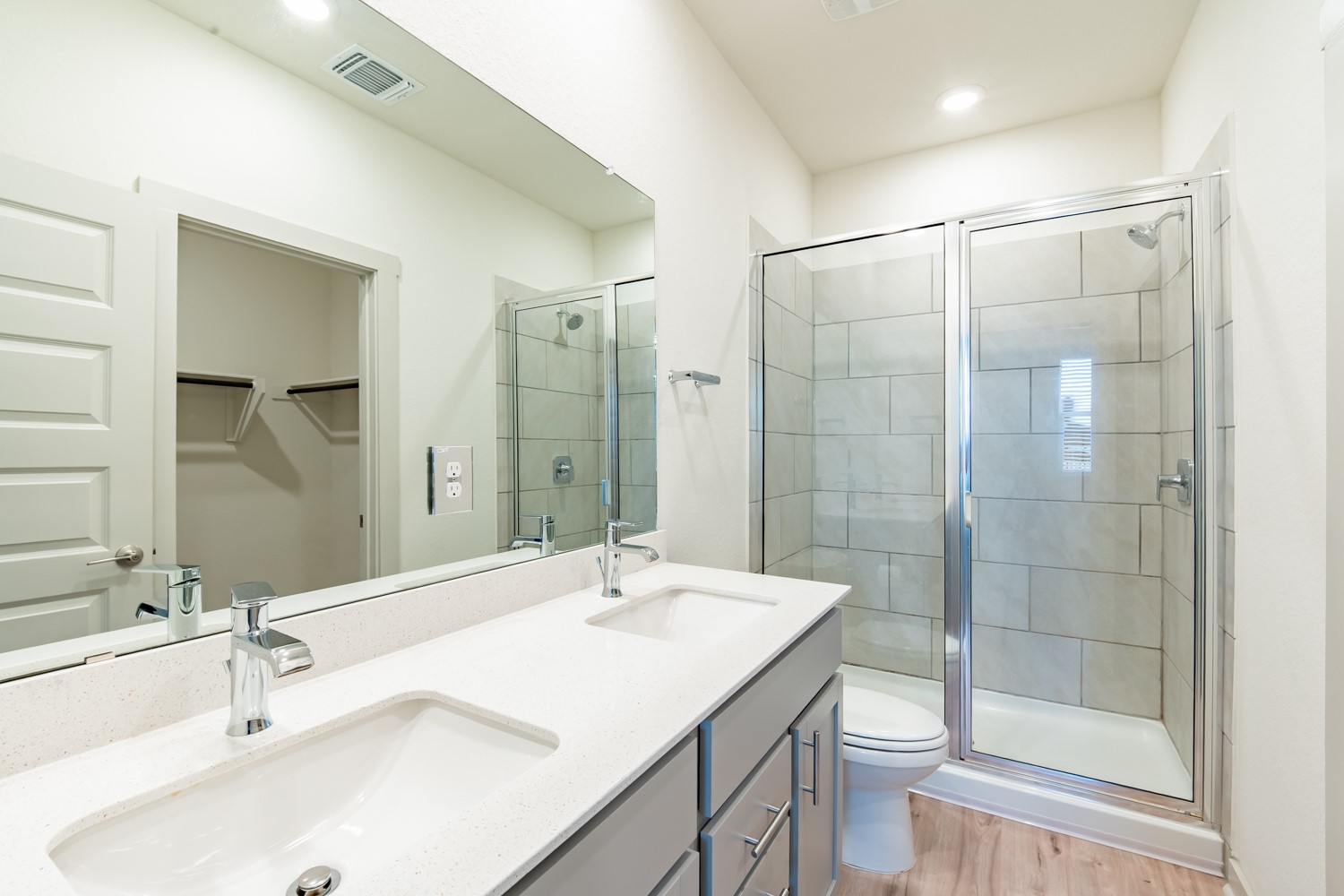 10801 Meris Lane Austin, TX 78754 - Photo 12 of 18 Double vanity and a tiled glass-enclosed shower create a modern, efficient space.