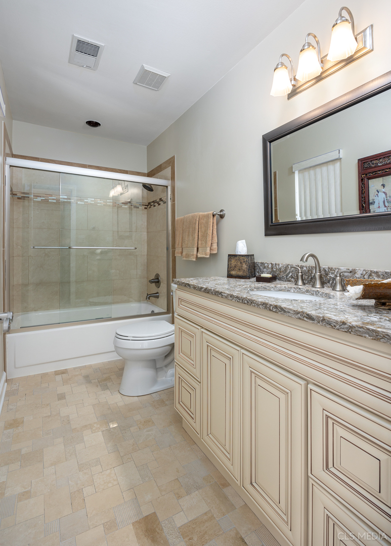 739 Old Barn Road Lake Barrington, IL 60010 - Photo 21 of 37 a bathroom with a granite countertop sink a toilet a mirror and shower