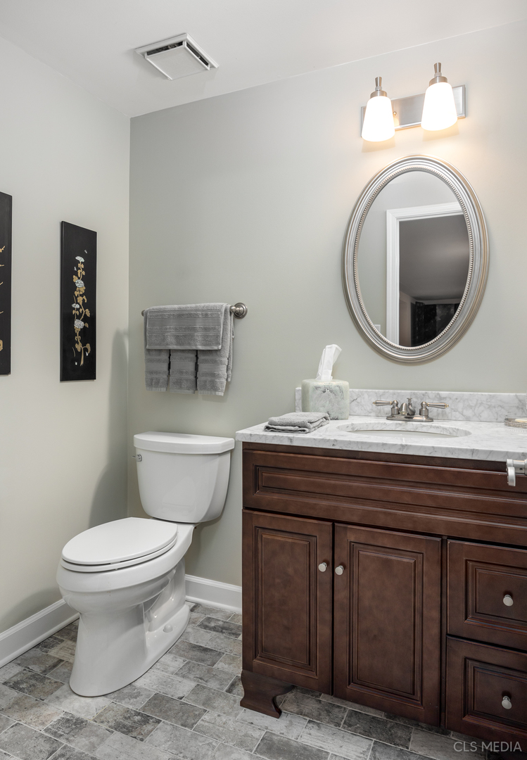 739 Old Barn Road Lake Barrington, IL 60010 - Photo 27 of 37 a bathroom with a toilet a sink and mirror
