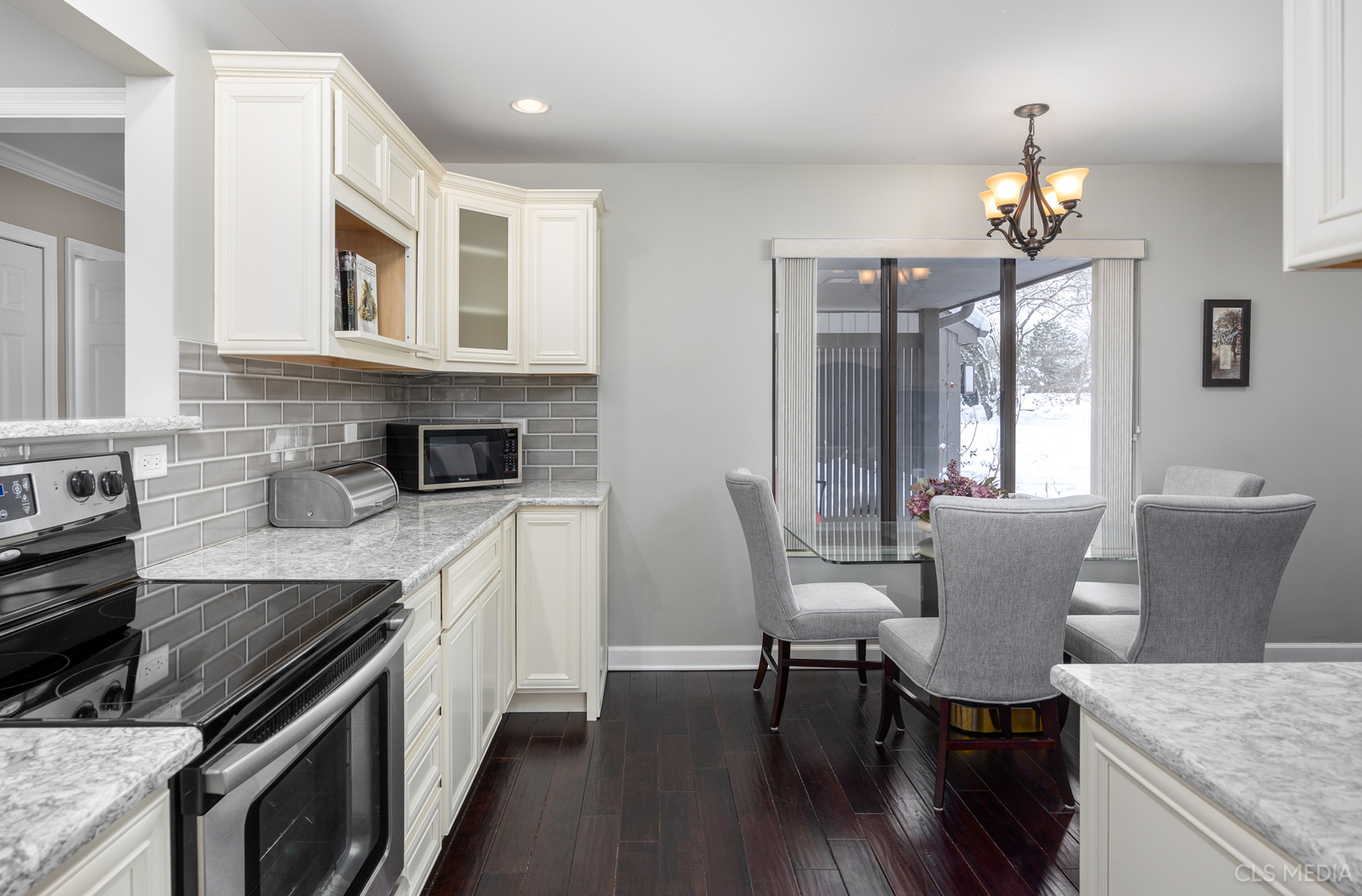 739 Old Barn Road Lake Barrington, IL 60010 - Photo 7 of 37 a kitchen with stainless steel appliances granite countertop a stove top oven a sink dishwasher a dining table and chairs with wooden floor