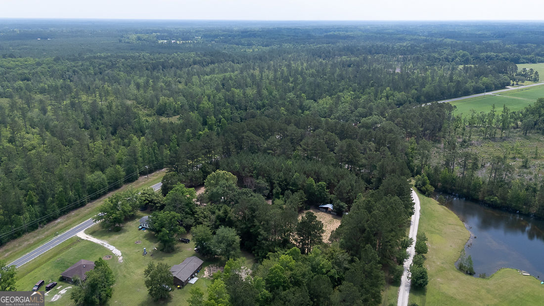 0 Old Louisville Road, Unit LOT 5 Guyton, GA 31312 - Photo 3 of 18 an aerial view of green landscape with trees houses and lake view