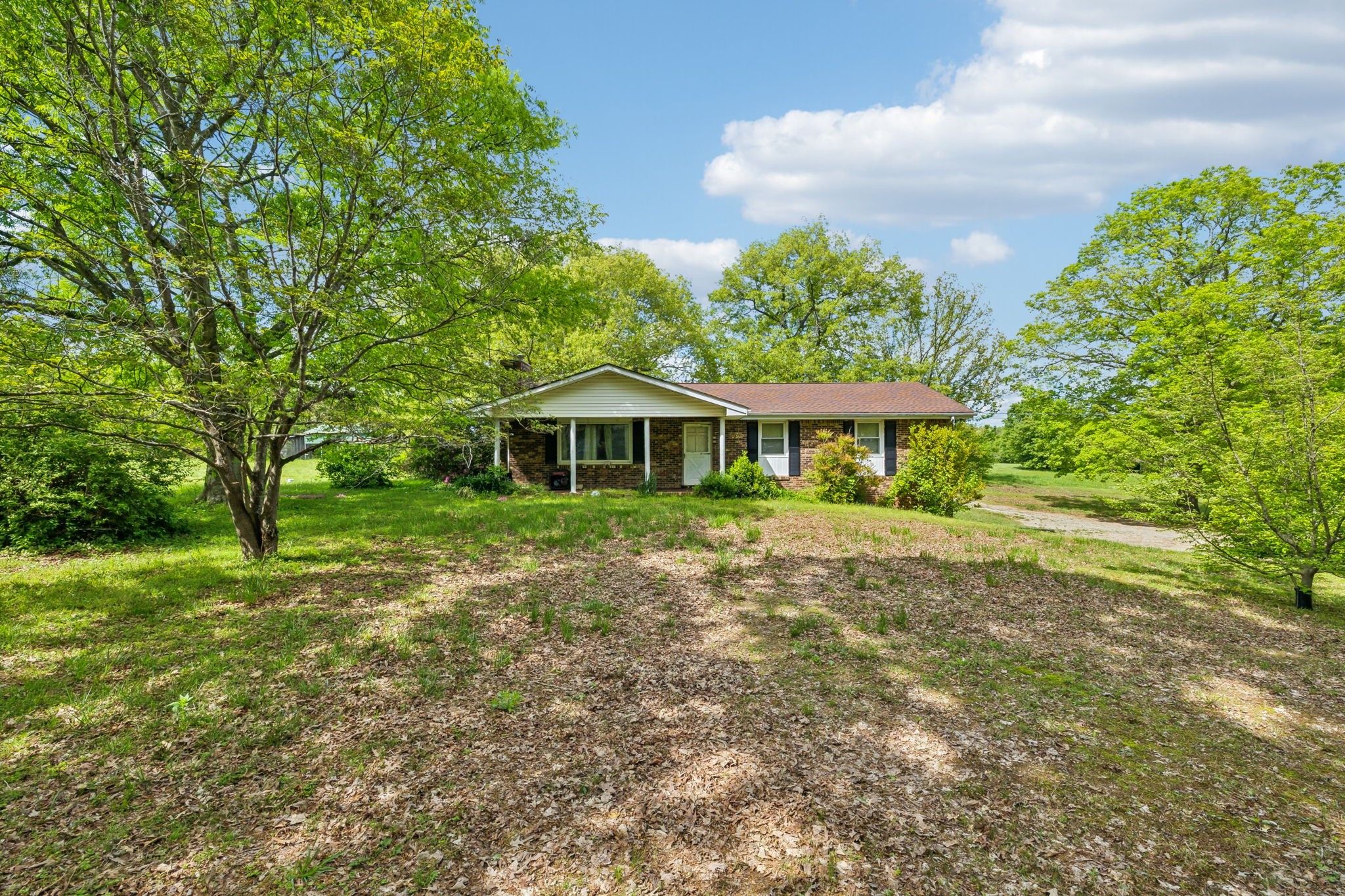 10924 Rials Branch Road Bon Aqua, TN 37025 - Photo 21 of 25 a front view of a house with a yard