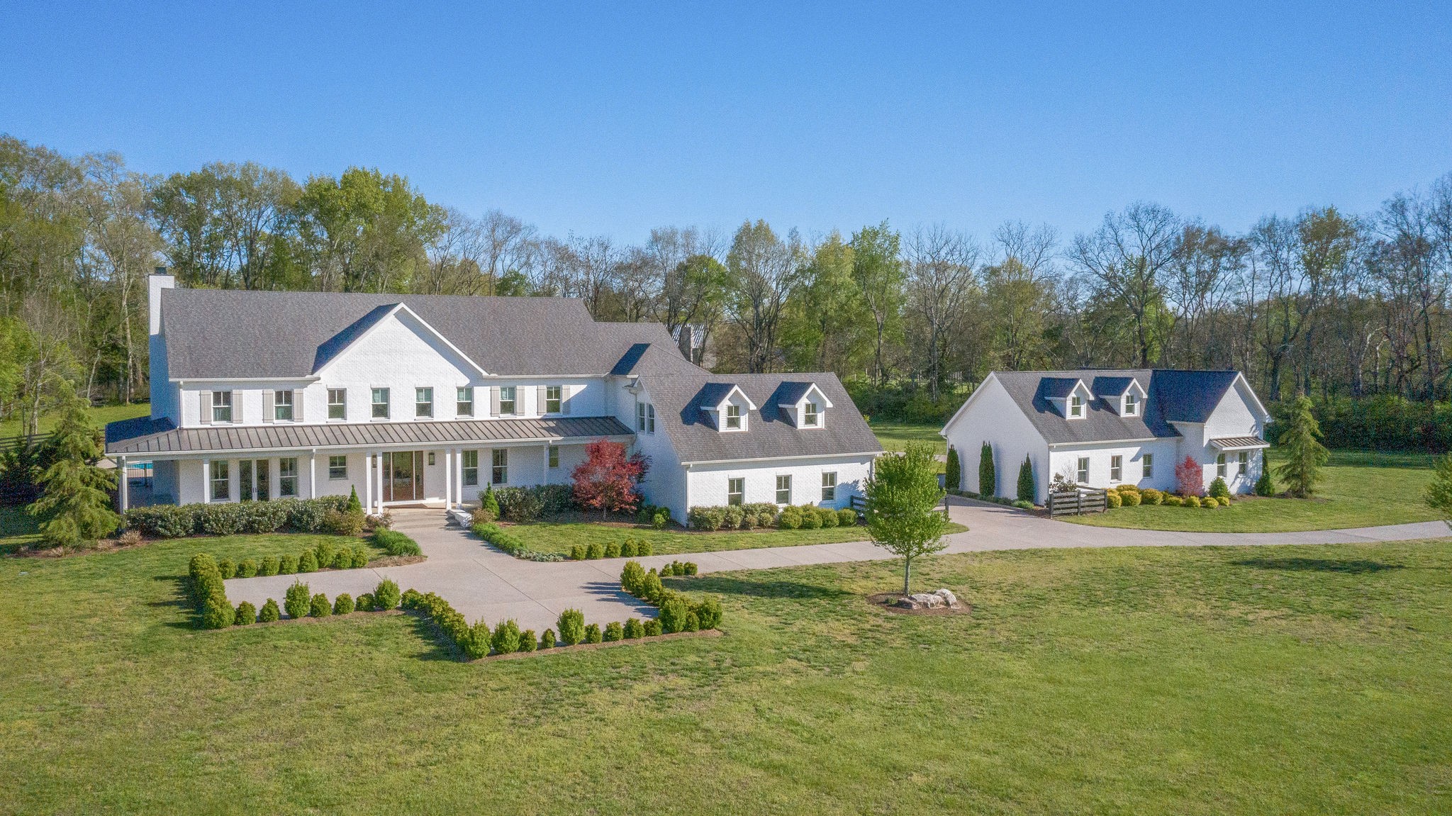 4224 Two Rivers Lane Franklin, TN 37069 - Photo 1 of 50 a view of a big house with a big yard and large trees