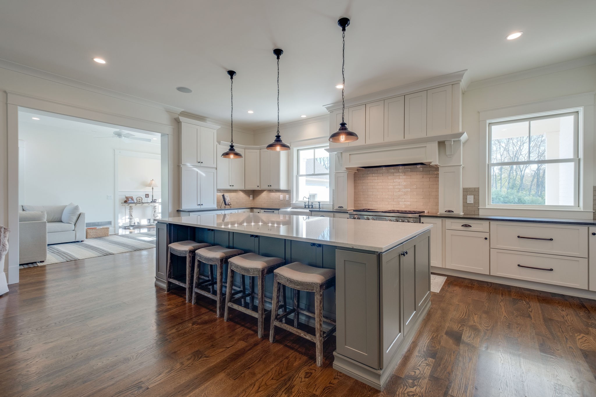 4224 Two Rivers Lane Franklin, TN 37069 - Photo 15 of 50 a kitchen with stainless steel appliances granite countertop a stove a refrigerator a kitchen island a dining table and chairs with wooden floor