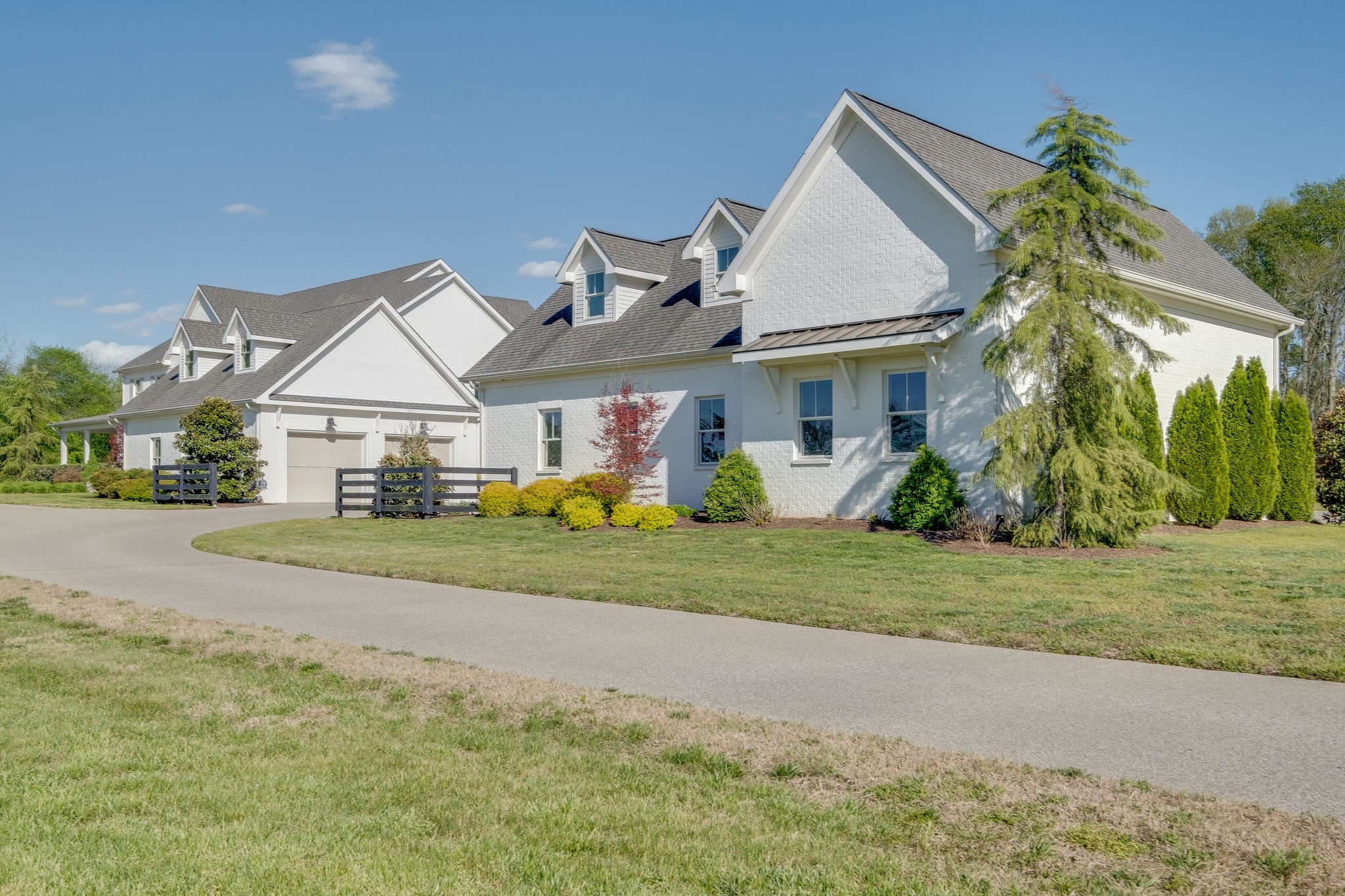 4224 Two Rivers Lane Franklin, TN 37069 - Photo 3 of 50 a front view of a house with a yard and potted plants