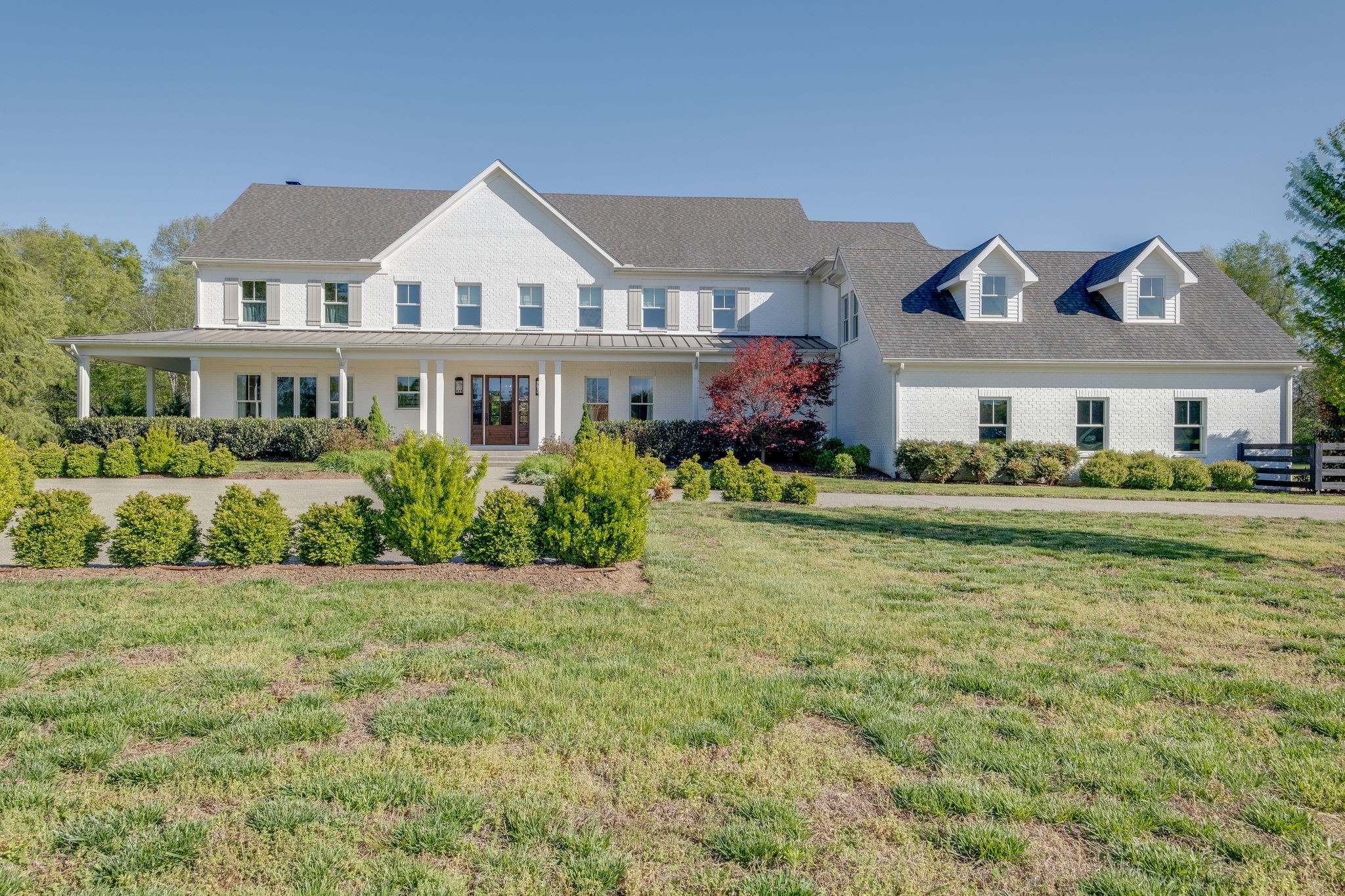 4224 Two Rivers Lane Franklin, TN 37069 - Photo 4 of 50 a front view of a house with a garden and plants