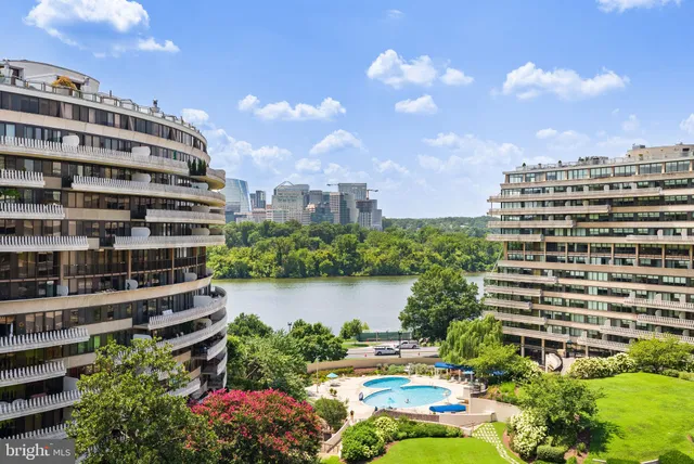 a view of a city with tall buildings and a big yard