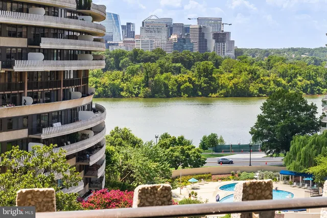 a view of a lake with a building and outdoor seating