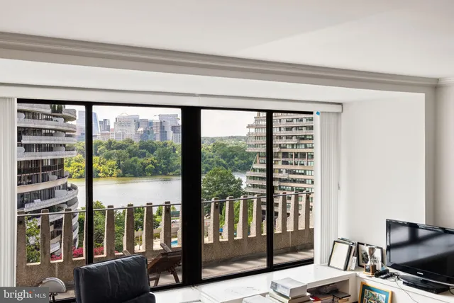 a living room with furniture and a floor to ceiling window