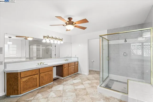 a bathroom with a sink double vanity granite and a mirror