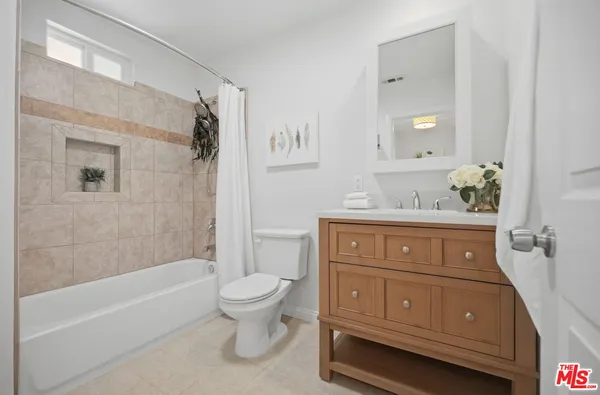 a bathroom with a sink a toilet and bathtub