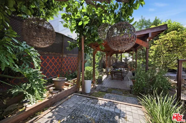 a view of a patio with table and chairs and potted plants