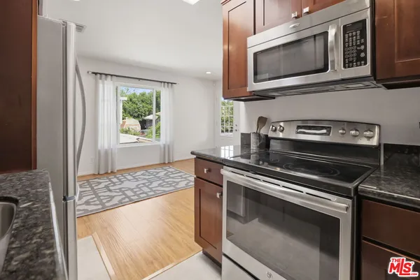 a kitchen with a stove microwave and sink