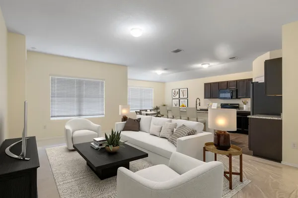 a living room with furniture and a lamp