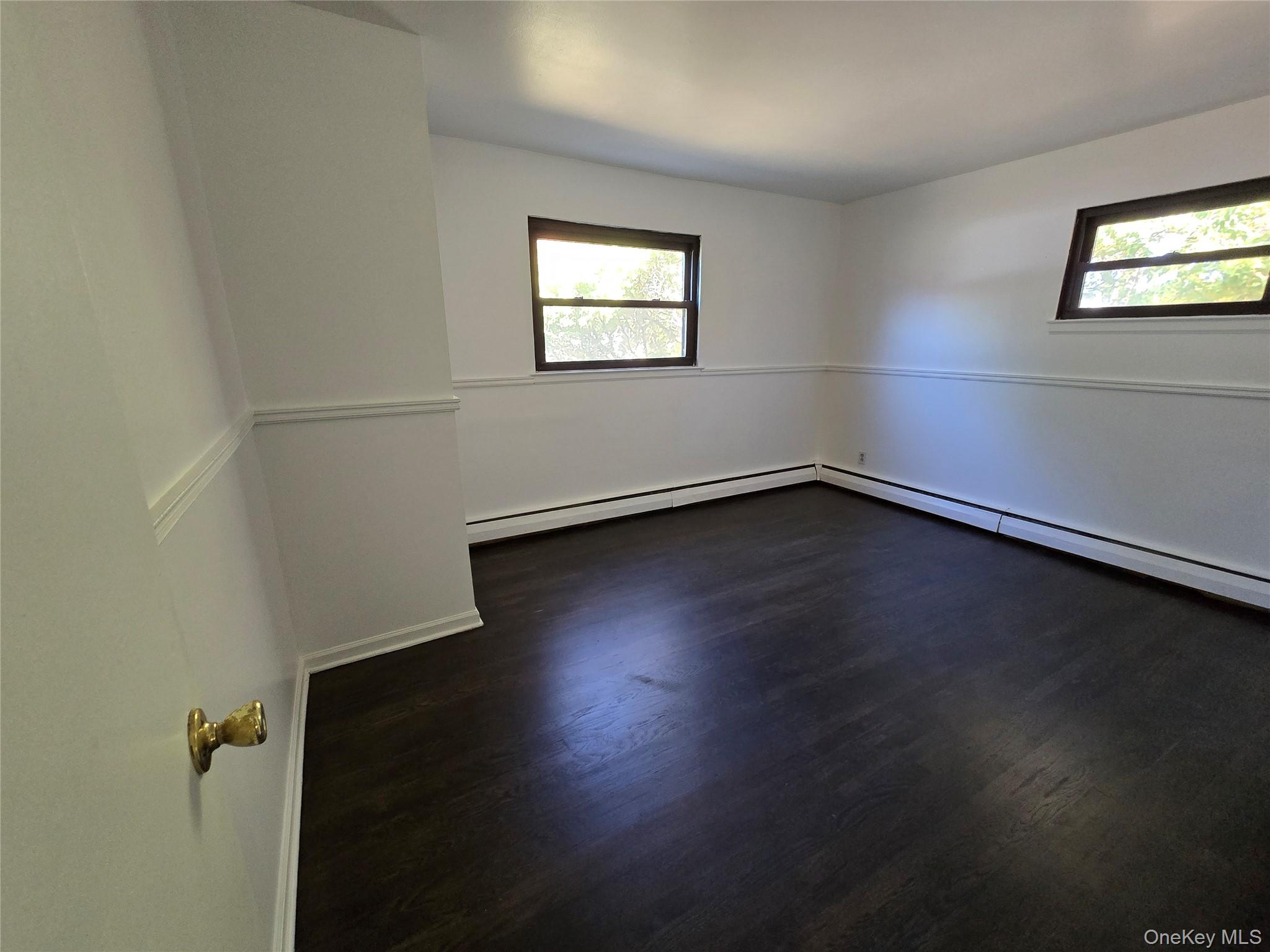 24 Oakbrook Road Ossining, NY 10562 - Photo 11 of 17 an empty room with wooden floor and windows