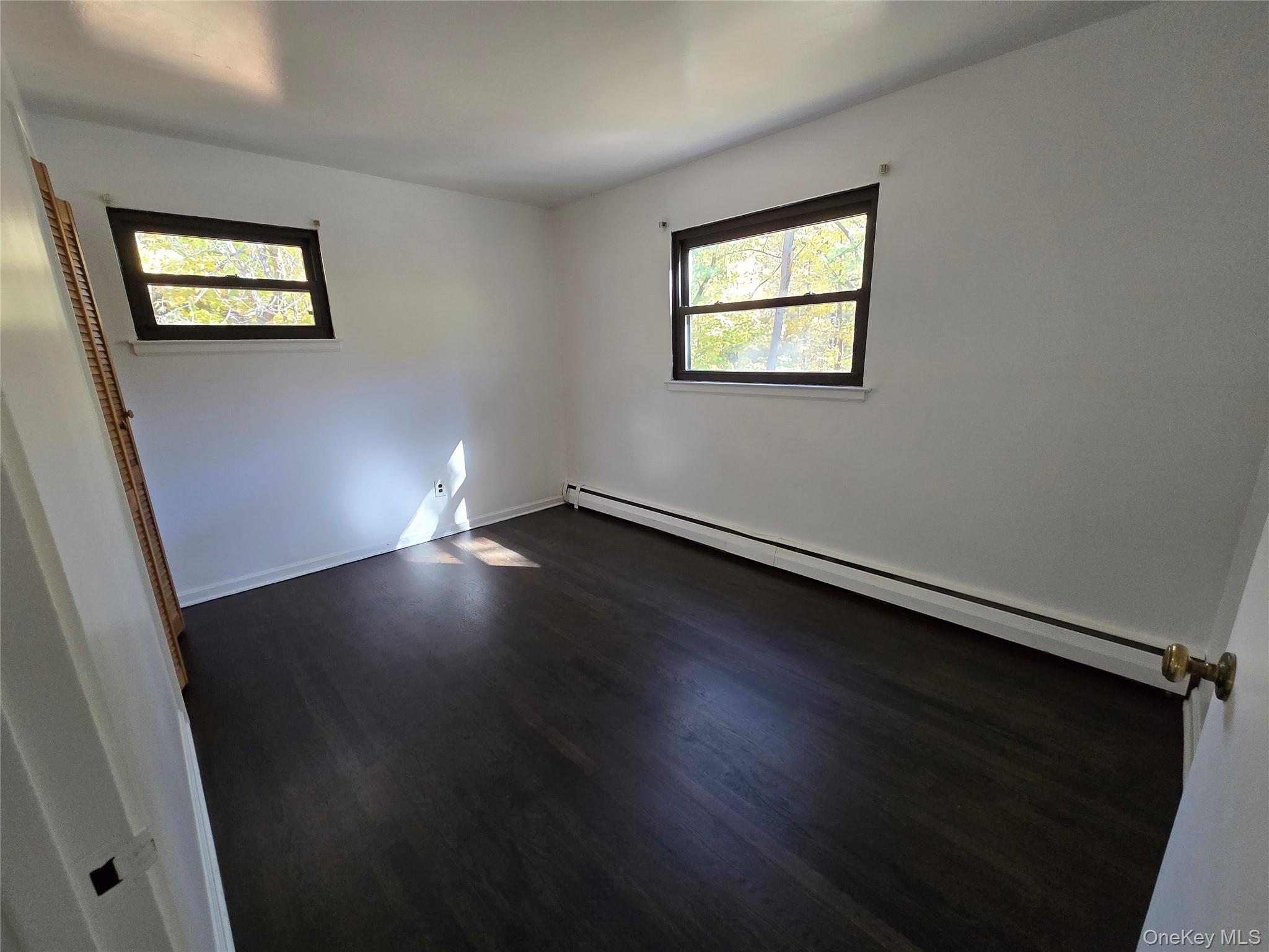 24 Oakbrook Road Ossining, NY 10562 - Photo 12 of 17 an empty room with wooden floor and windows