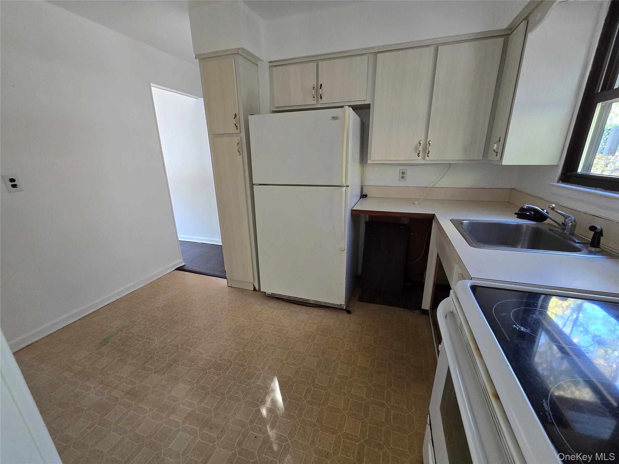 24 Oakbrook Road Ossining, NY 10562 - Photo 9 of 17 a kitchen with a refrigerator and a sink