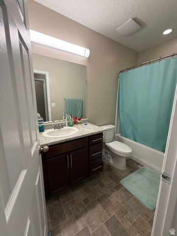 118 Tram Rock Rd. Lake Point, UT 84074 - Photo 25 of 34 Bathroom featuring a dark wood vanity with a white countertop and integrated sink, a full-width mirror, a tub/shower combination