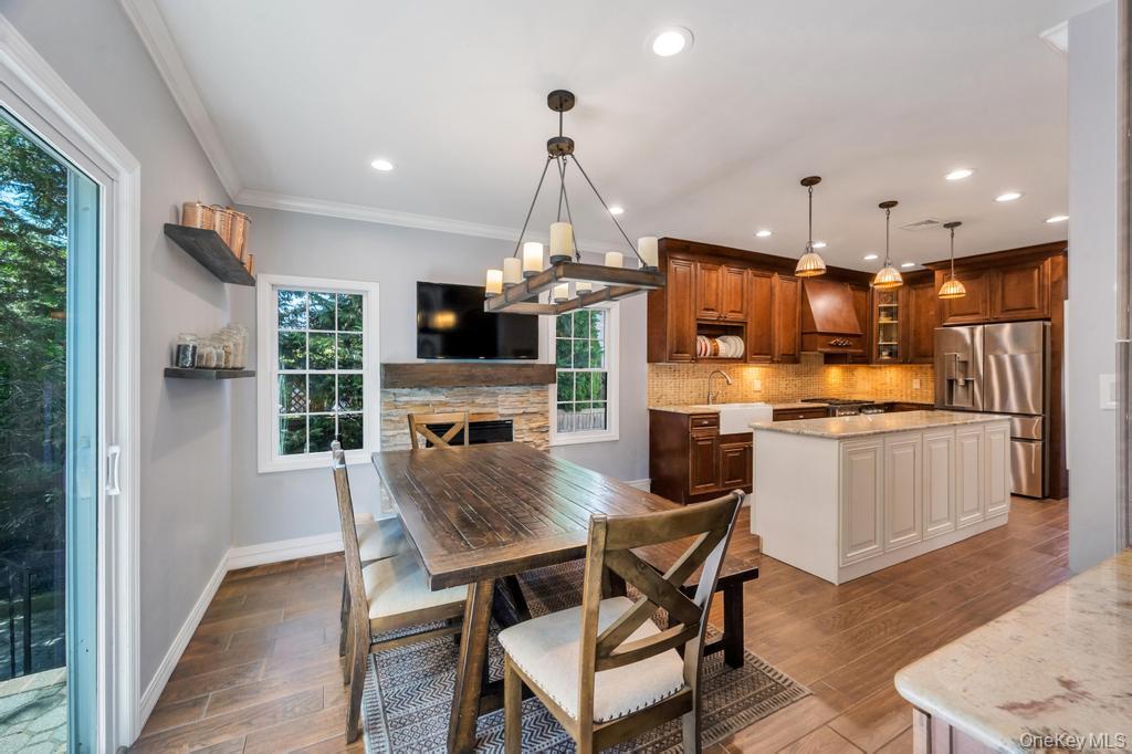 357 Wynsum Avenue Merrick, NY 11566 - Photo 23 of 40 a kitchen with stainless steel appliances kitchen island granite countertop a dining table chairs and granite counter tops