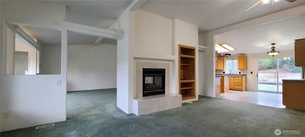 an empty room with windows closet and chandelier fan