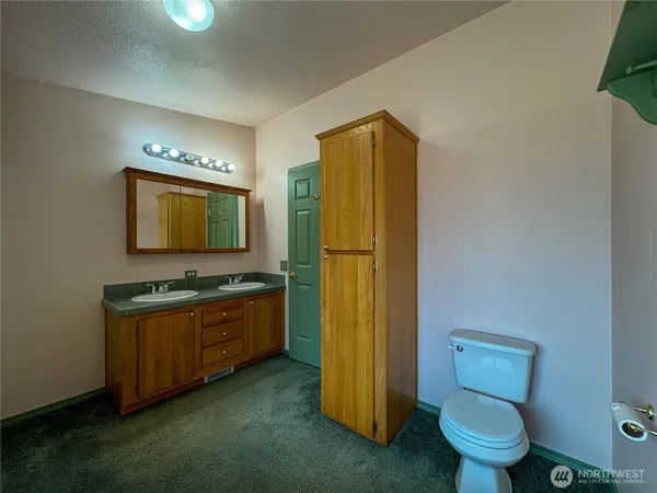 an empty room with windows and closet