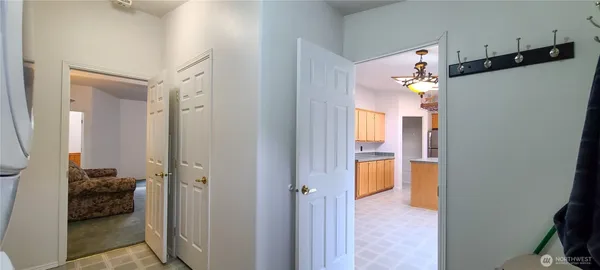 a view of a hallway with closet and a livingroom view