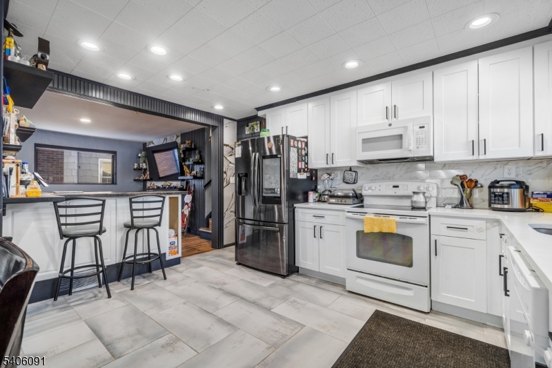 460 Grove Street Rahway, NJ 07065 - Photo 11 of 26 a kitchen with refrigerator and cabinets