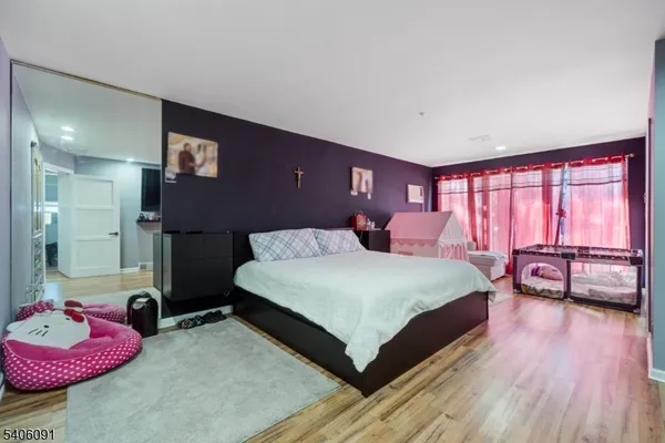 a spacious bedroom with a bed and a couch