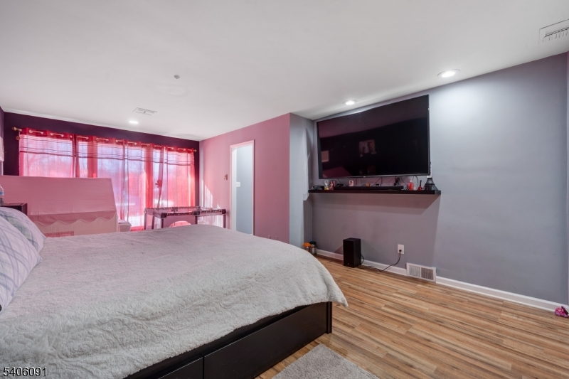 460 Grove Street Rahway, NJ 07065 - Photo 14 of 26 a bedroom with a bed and a flat screen tv