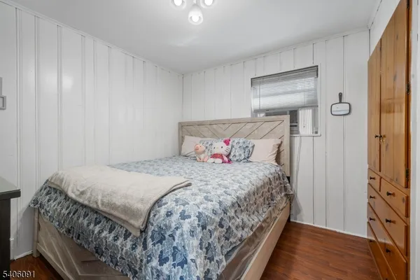 a bedroom with a bed and a mirror