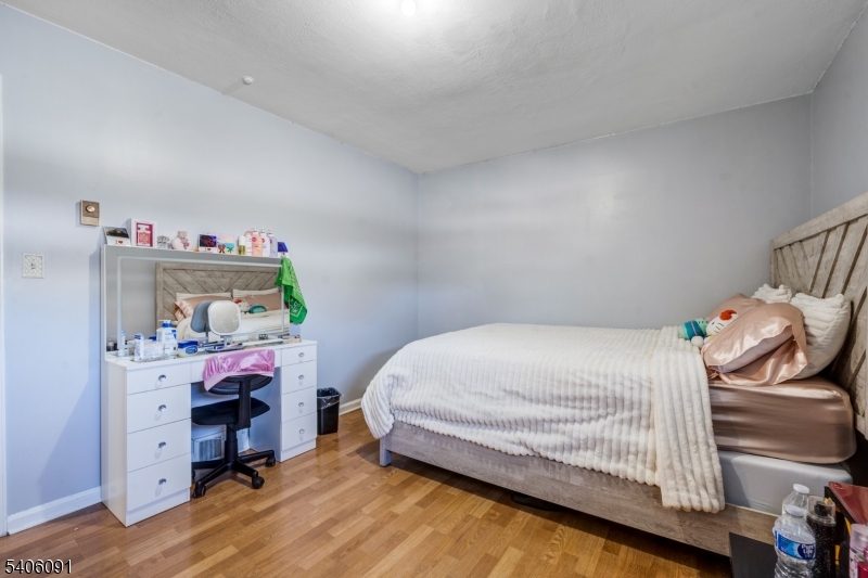 460 Grove Street Rahway, NJ 07065 - Photo 20 of 26 a bedroom with a bed and a dresser