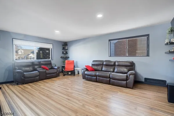 a living room with furniture and a wooden floor