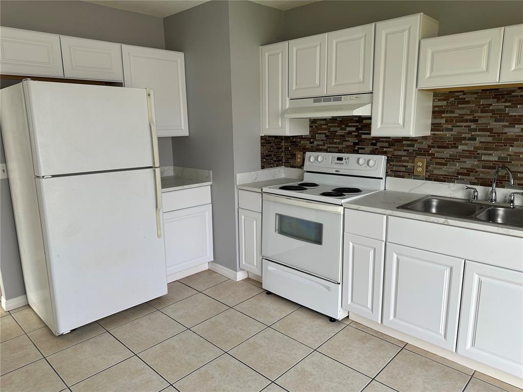 425 Ricold Terrace Port Charlotte, FL 33954 - Photo 4 of 10 a white refrigerator freezer sitting in a kitchen