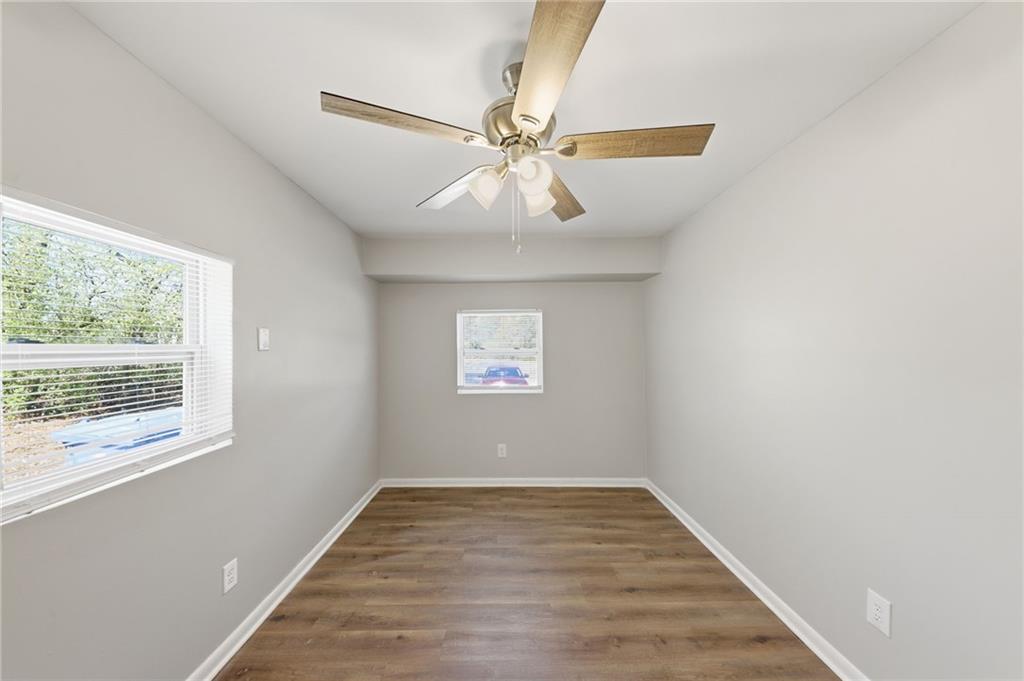2086 Fairburn Road Southwest Atlanta, GA 30331 - Photo 13 of 28 a view of an empty room with window and wooden floor