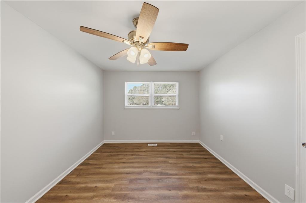2086 Fairburn Road Southwest Atlanta, GA 30331 - Photo 15 of 28 wooden floor in an empty room with a window